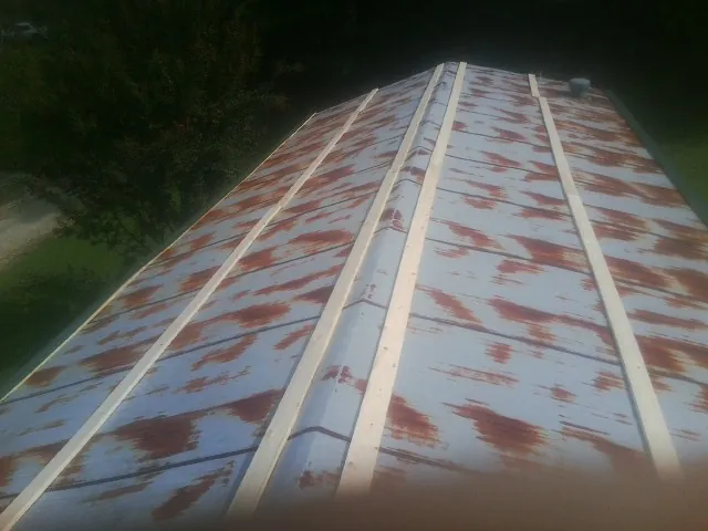 Rusted metal roof panels with new wood purlins before replacement — Storm Damage Roof Repair in Ladson by Roofing Brothers